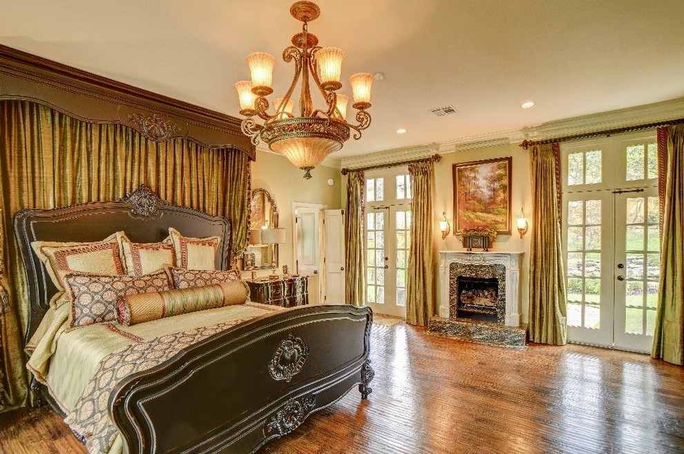 This is an example of a medium sized classic master bedroom in Other with beige walls, dark hardwood flooring, a standard fireplace, a stone fireplace surround and brown floors.