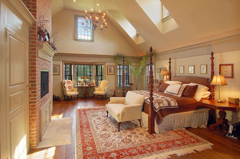 Design ideas for an expansive traditional master bedroom in Chicago with white walls, medium hardwood flooring and a standard fireplace.