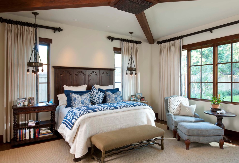 Example of a tuscan master medium tone wood floor bedroom design in San Diego