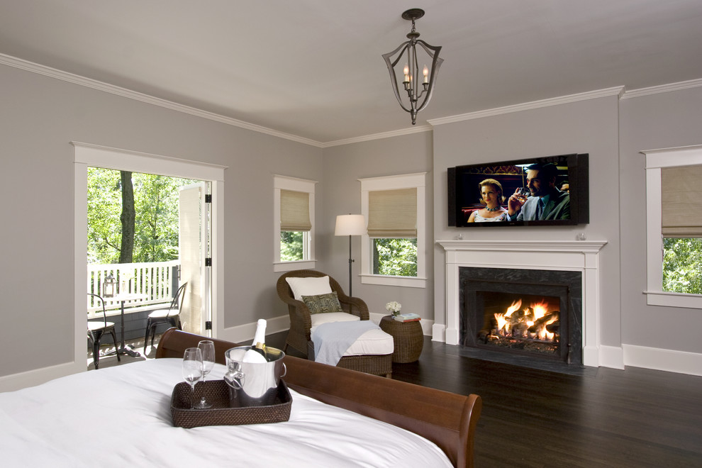 Bedroom - mid-sized traditional master dark wood floor and brown floor bedroom idea in New York with gray walls, a standard fireplace and a stone fireplace