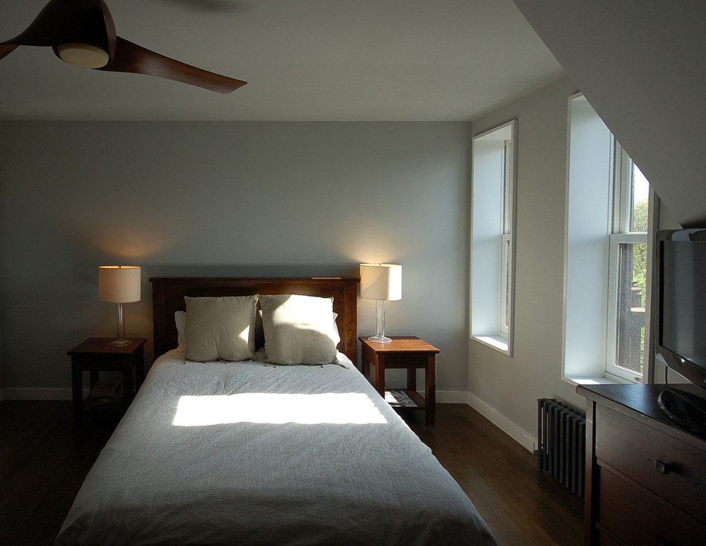 Mid-sized transitional master dark wood floor and brown floor bedroom photo in New York with gray walls and no fireplace