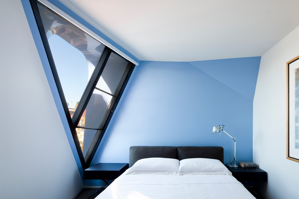 Large contemporary master bedroom in Melbourne with blue walls.