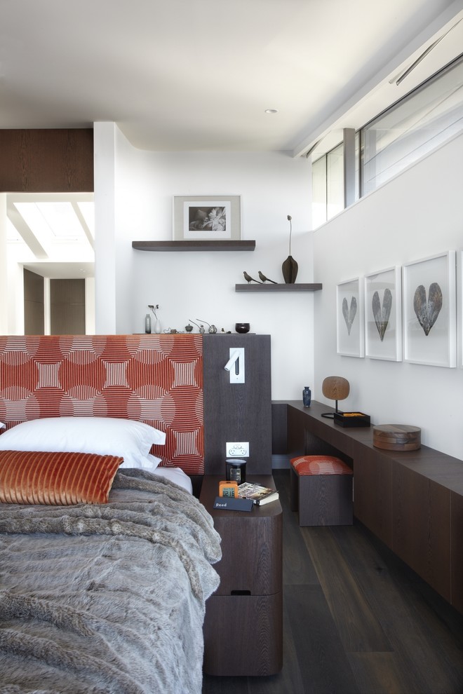 Contemporary bedroom in Sydney with white walls and dark hardwood flooring.