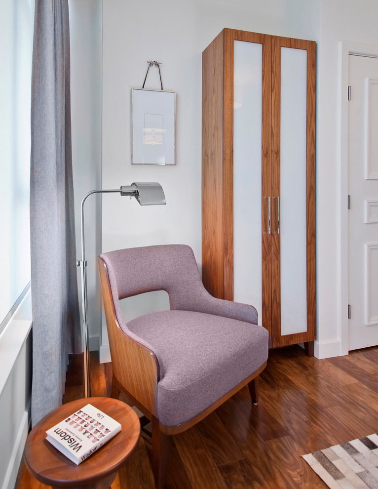 This is an example of a contemporary bedroom in Vancouver with white walls and medium hardwood flooring.