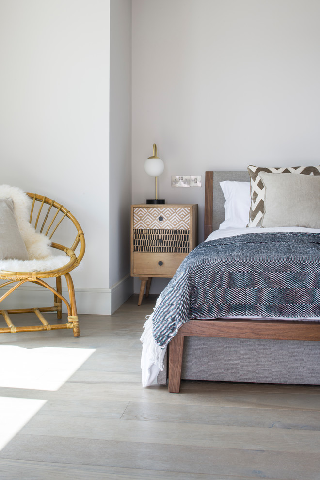Beach style guest bedroom in Cornwall with grey walls and medium hardwood flooring.