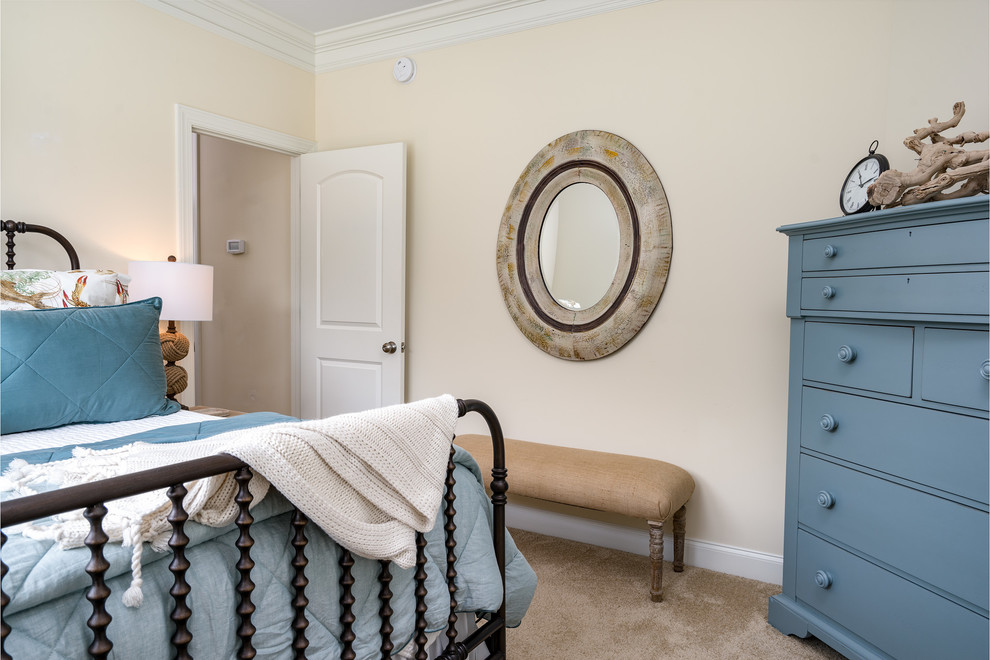 Photo of a small nautical guest bedroom in Wilmington with beige walls and carpet.