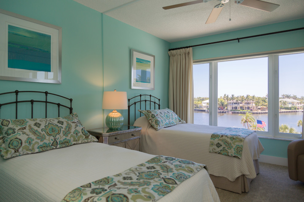 Diseño de habitación de invitados costera sin chimenea con paredes azules, moqueta y suelo beige