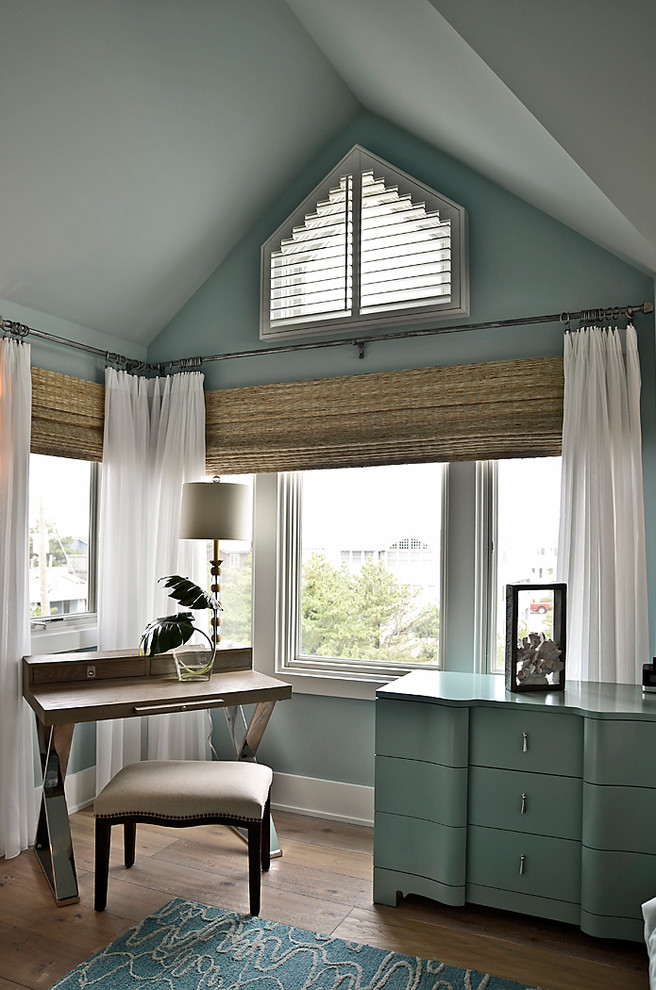 Design ideas for a large coastal master bedroom in Philadelphia with blue walls and light hardwood flooring.