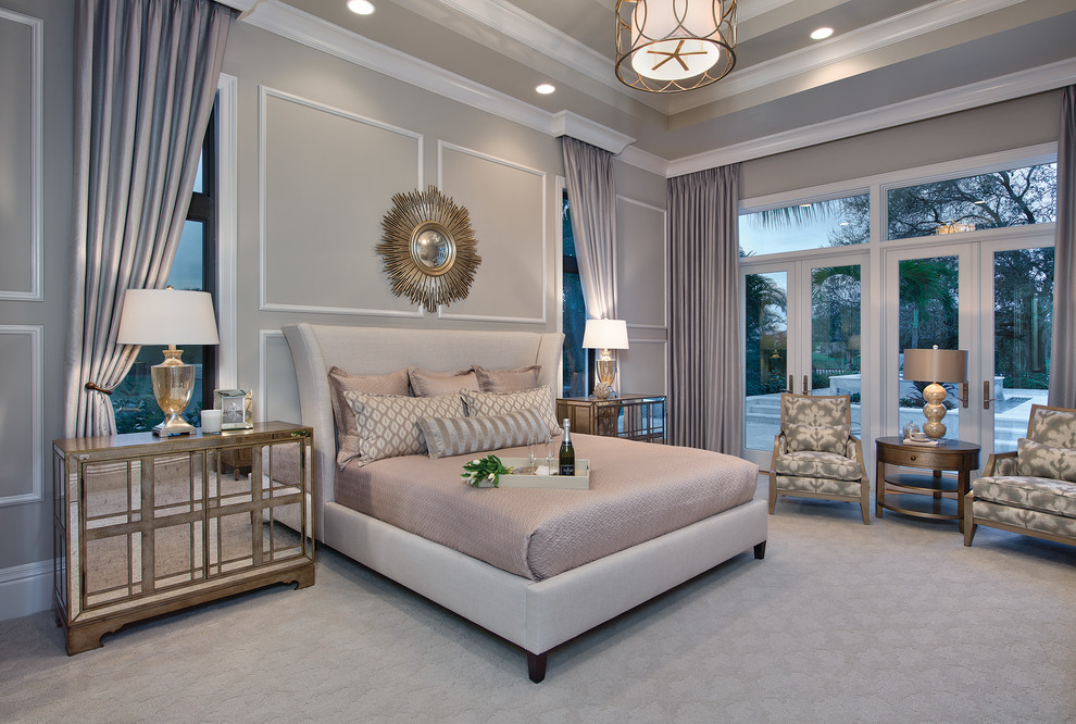 This is an example of a large classic master bedroom in Miami with beige walls and carpet.