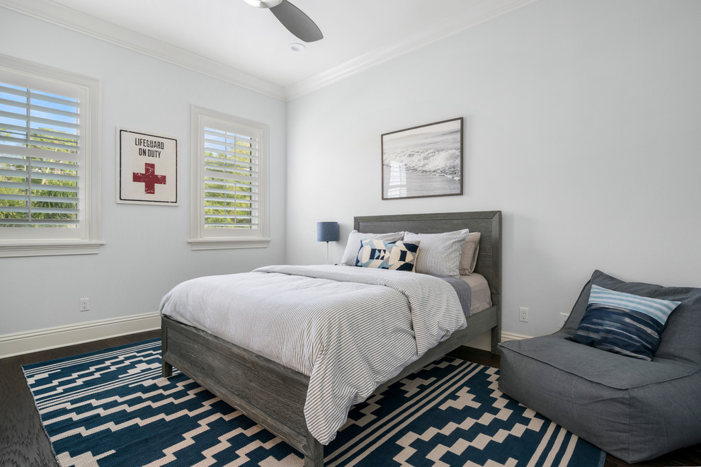 Mid-sized beach style guest dark wood floor and brown floor bedroom photo in Orlando with gray walls and no fireplace