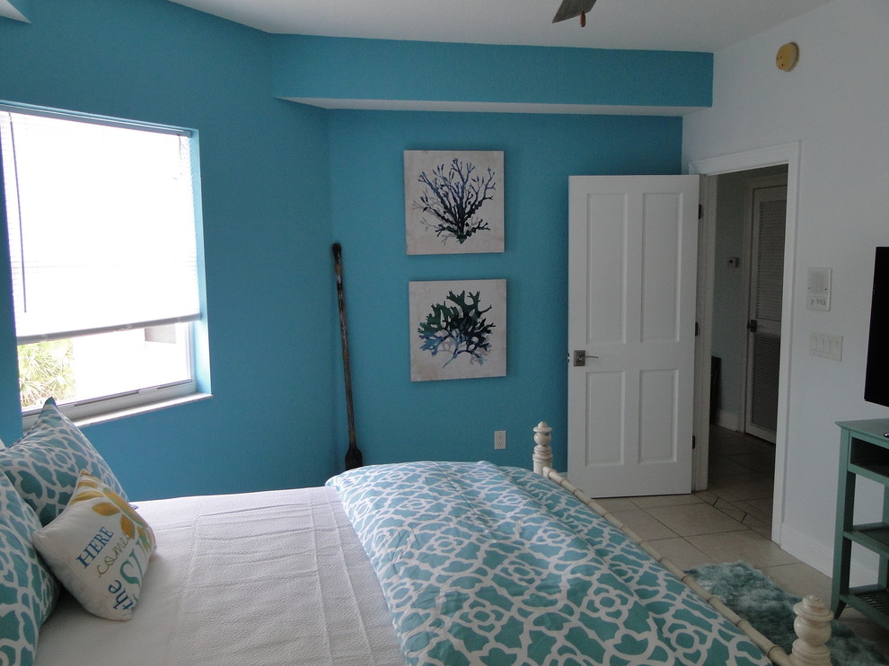 Coastal bedroom in Tampa with blue walls.