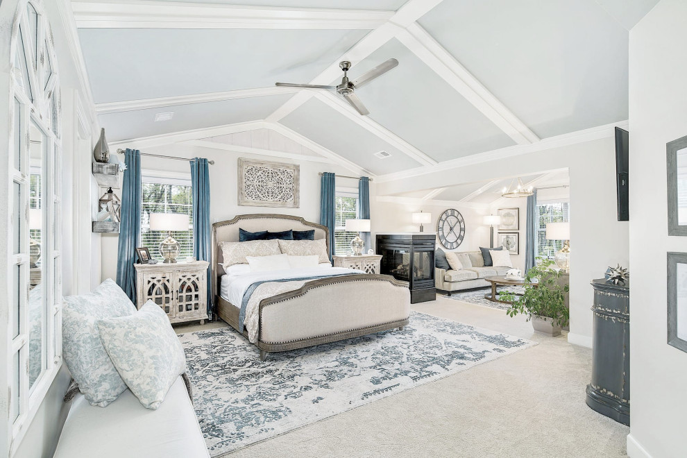 Bedroom - huge coastal master carpeted, beige floor, vaulted ceiling and wood wall bedroom idea in Philadelphia with beige walls, a two-sided fireplace and a tile fireplace