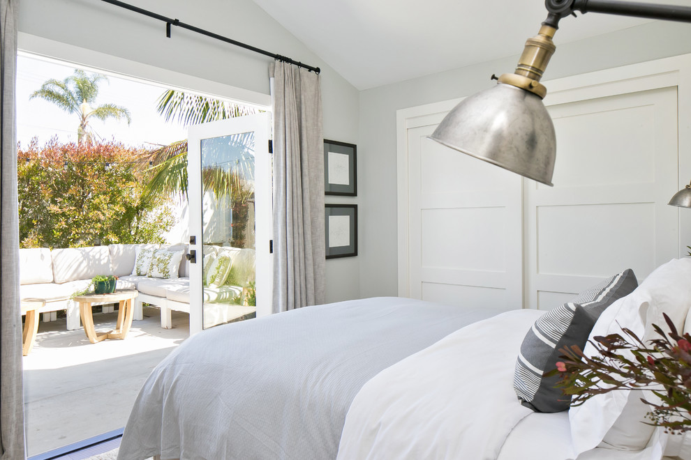 Small farmhouse master bedroom in Orange County with grey walls.