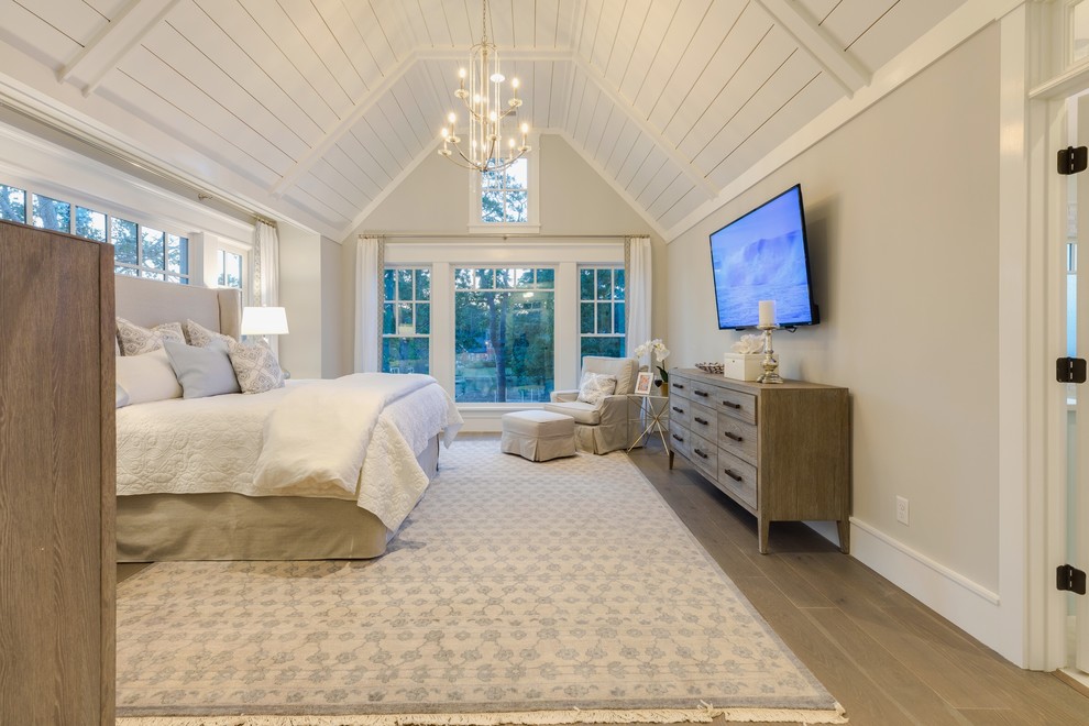Inspiration for a large coastal master medium tone wood floor and gray floor bedroom remodel in Other with gray walls