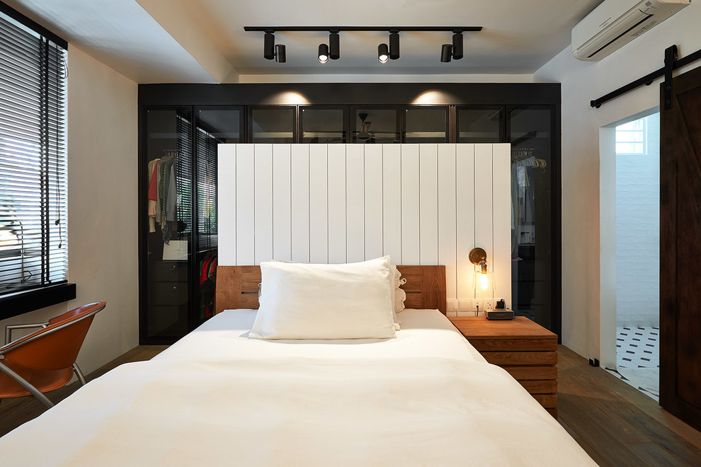 Inspiration for a contemporary medium tone wood floor bedroom remodel in Singapore with white walls