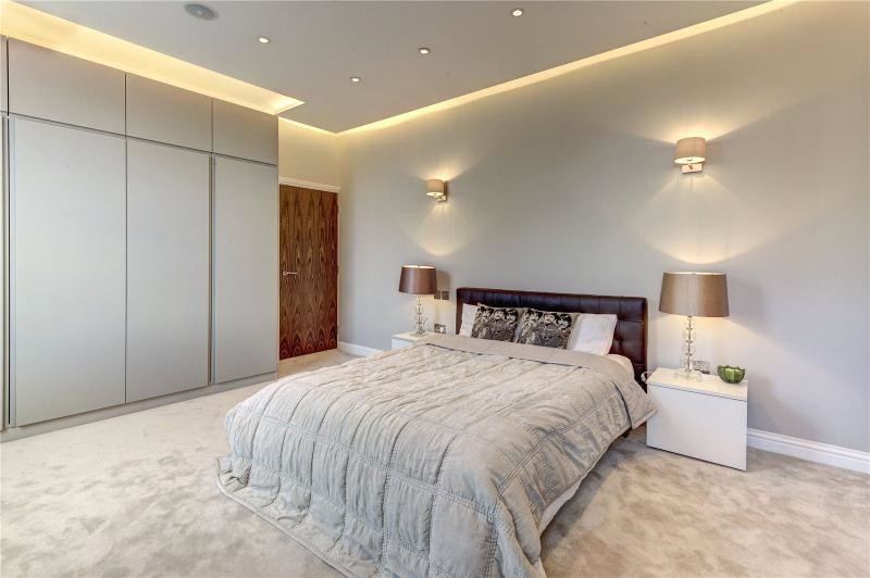 Imagen de dormitorio principal contemporáneo grande con paredes grises y moqueta
