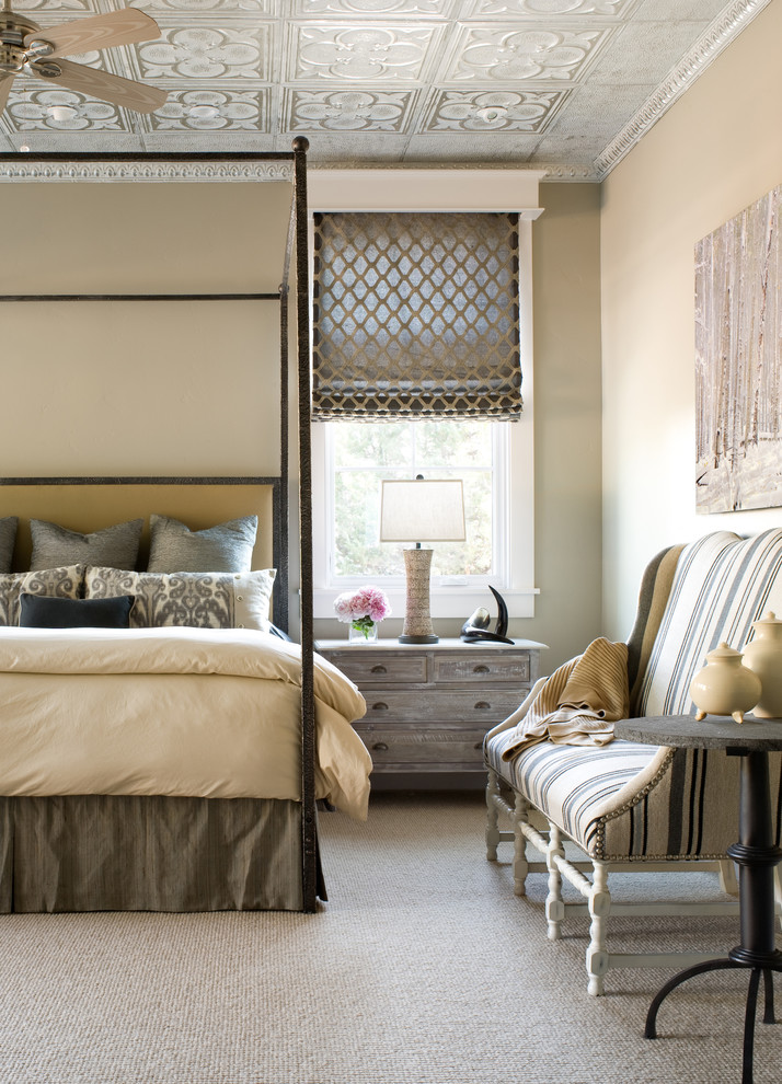 This is an example of a traditional bedroom in Denver with beige walls and carpet.