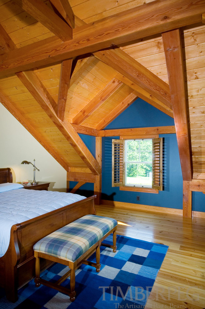 This is an example of a rural guest bedroom in Burlington with blue walls and medium hardwood flooring.