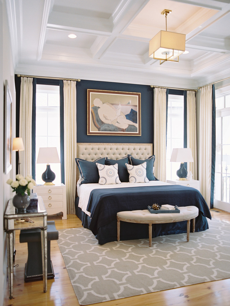 Example of a transitional medium tone wood floor bedroom design in Other with blue walls