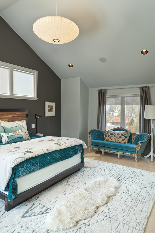 Example of a trendy master light wood floor bedroom design in Houston with gray walls