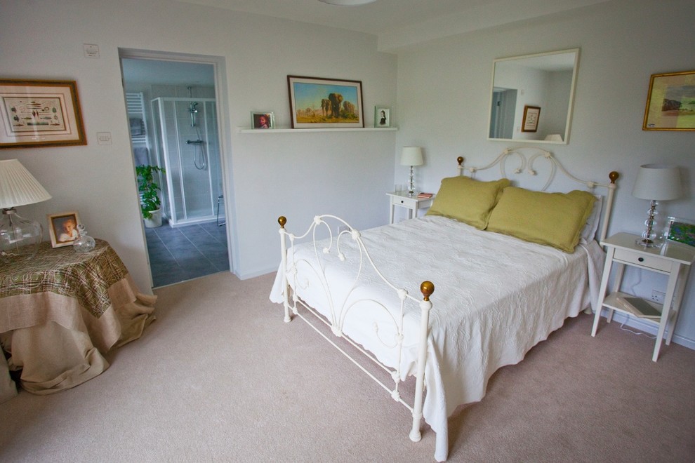 Photo of a small classic master bedroom in Miami with white walls and carpet.