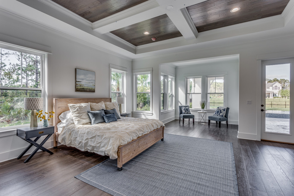 Classic grey and brown bedroom in Jacksonville with white walls, dark hardwood flooring and brown floors.