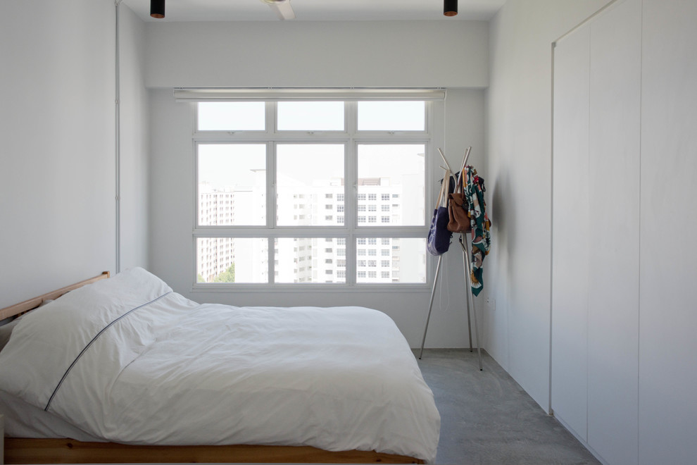 Diseño de dormitorio principal actual de tamaño medio con paredes blancas, suelo de cemento y suelo gris