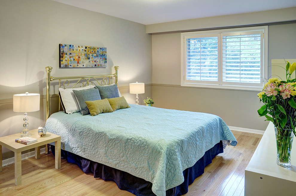 Photo of a medium sized guest bedroom in Toronto with grey walls, light hardwood flooring and no fireplace.