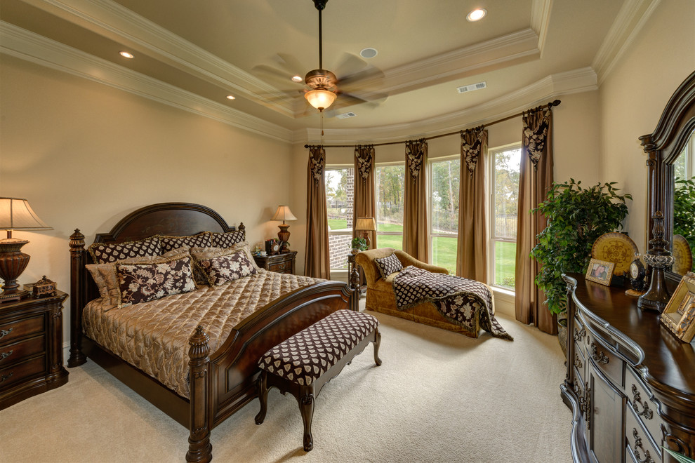 Example of a large tuscan master carpeted bedroom design in Dallas with beige walls and no fireplace
