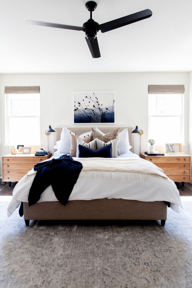 Traditional bedroom in Sacramento with white walls, dark hardwood flooring and grey floors.