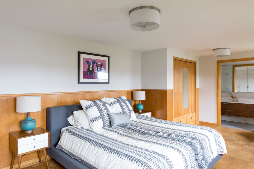 Example of a small 1960s master medium tone wood floor bedroom design in Portland with white walls