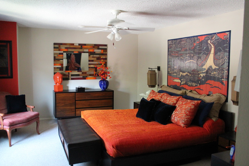 Medium sized world-inspired master bedroom in Dallas with orange walls.