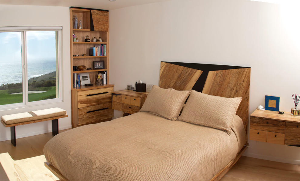 Imagen de habitación de invitados rural de tamaño medio sin chimenea con paredes blancas y suelo de madera clara