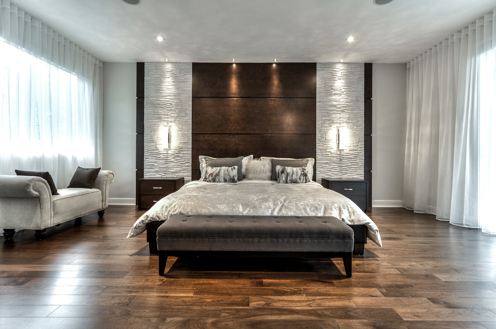 This is an example of an expansive modern master bedroom in Montreal.