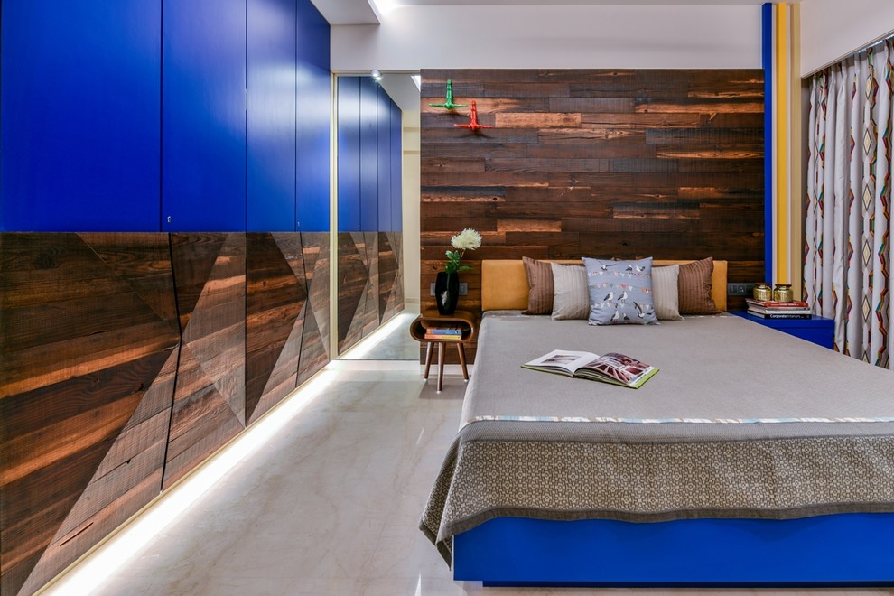 This is an example of a contemporary bedroom in Mumbai with white walls and grey floors.