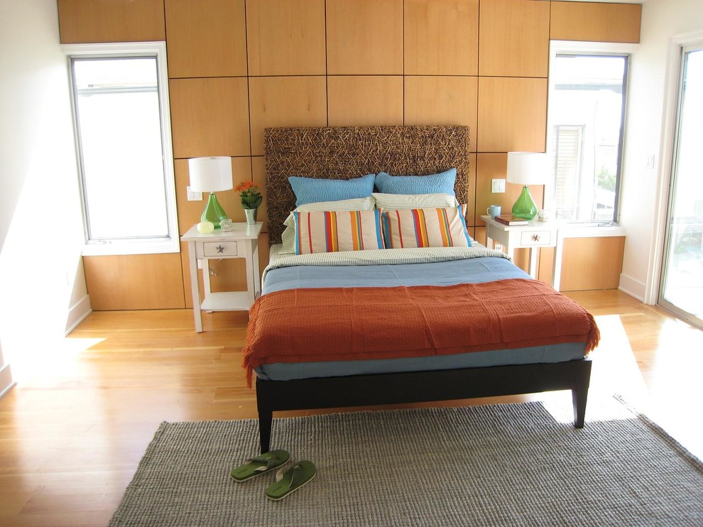 На фото: спальня в морском стиле с белыми стенами и паркетным полом среднего тона с