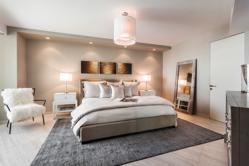 Photo of a contemporary master, grey and brown and grey and silver bedroom in Los Angeles with beige walls and beige floors.