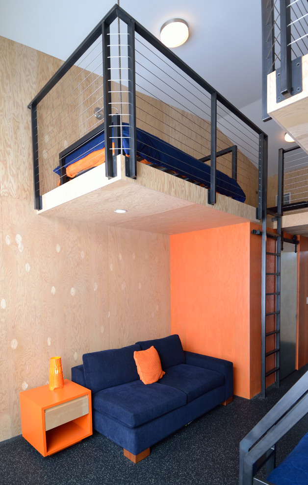 Example of a trendy loft-style bedroom design in Minneapolis with orange walls