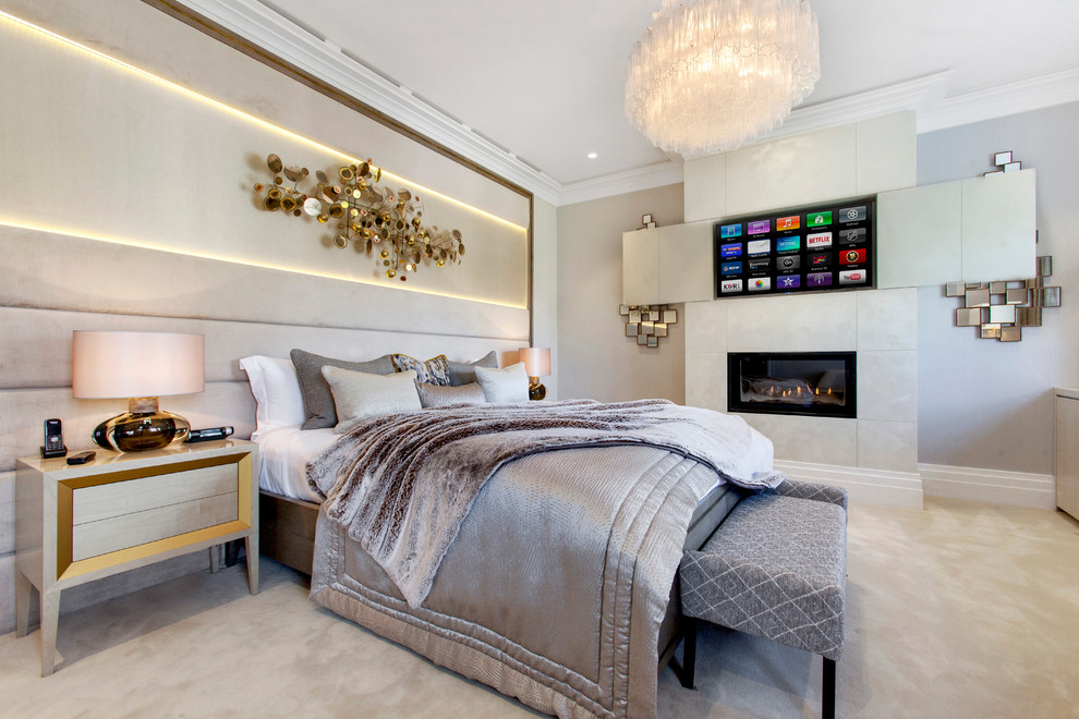Inspiration for a contemporary bedroom in London with beige walls, carpet and a standard fireplace.