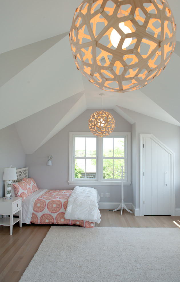 This is an example of a contemporary grey and pink bedroom in Boston with grey walls and feature lighting.