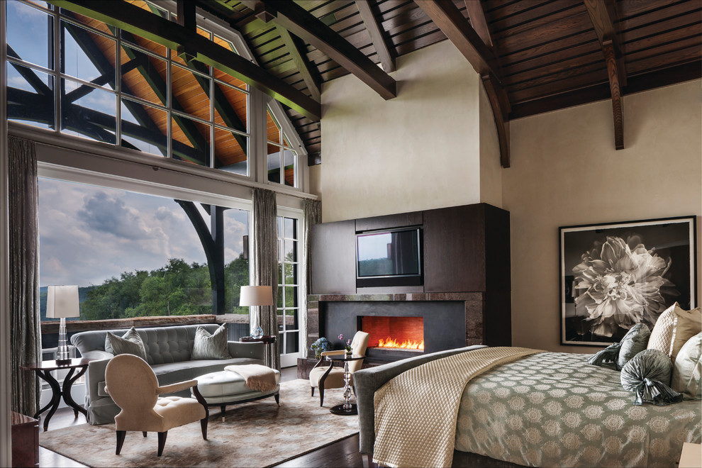 Imagen de dormitorio televisión contemporáneo con paredes beige, suelo de madera oscura y todas las chimeneas