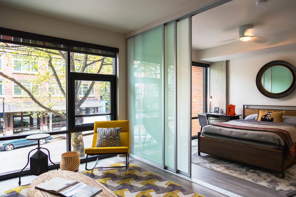 Photo of a contemporary bedroom in Seattle with beige walls, dark hardwood flooring and no fireplace.