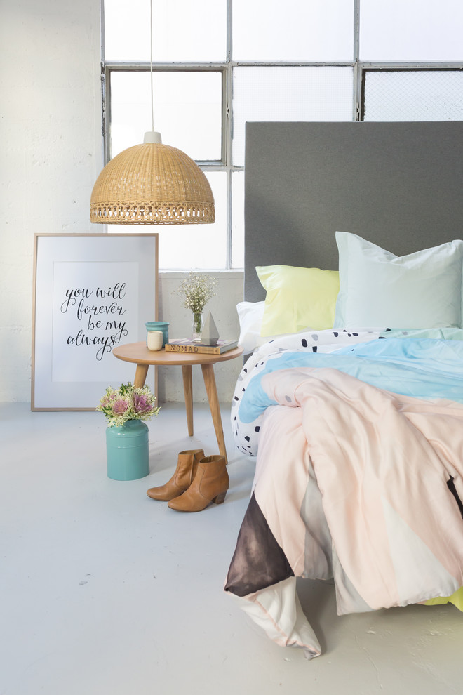 Example of a trendy loft-style concrete floor bedroom design in Melbourne