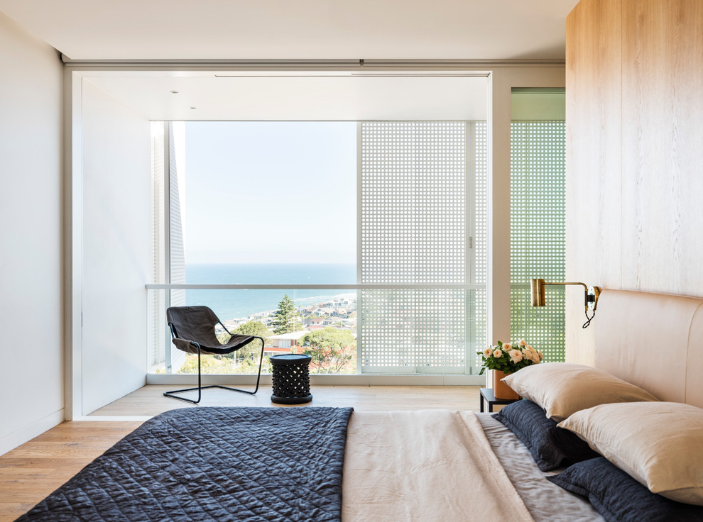 Bedroom - contemporary medium tone wood floor and brown floor bedroom idea in Sydney with white walls
