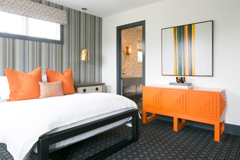 This is an example of a contemporary bedroom in Orange County with white walls, carpet, black floors and a feature wall.