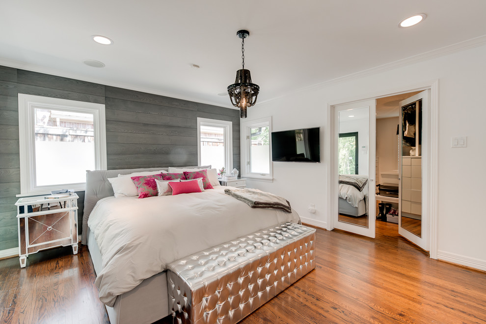 Photo of a contemporary grey and pink and grey and silver bedroom in Los Angeles with white walls, medium hardwood flooring and a feature wall.
