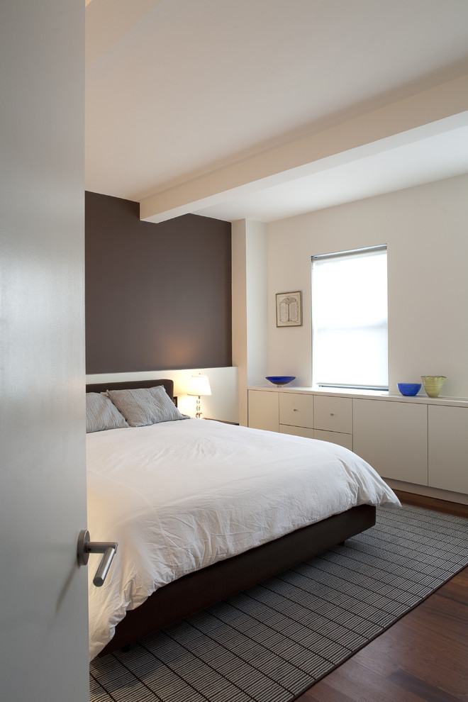 Inspiration for a contemporary dark wood floor bedroom remodel in New York with brown walls