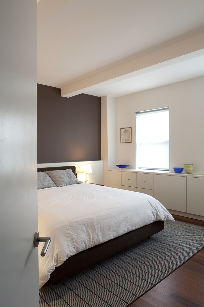 Modernes Schlafzimmer mit brauner Wandfarbe und dunklem Holzboden in New York