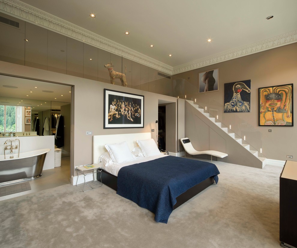 Photo of a large contemporary master bedroom in London with grey walls and carpet.