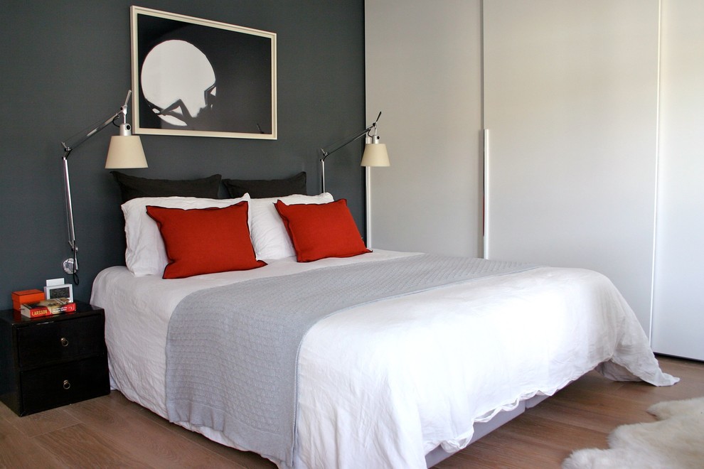 Inspiration for a contemporary bedroom in London with grey walls and light hardwood flooring.